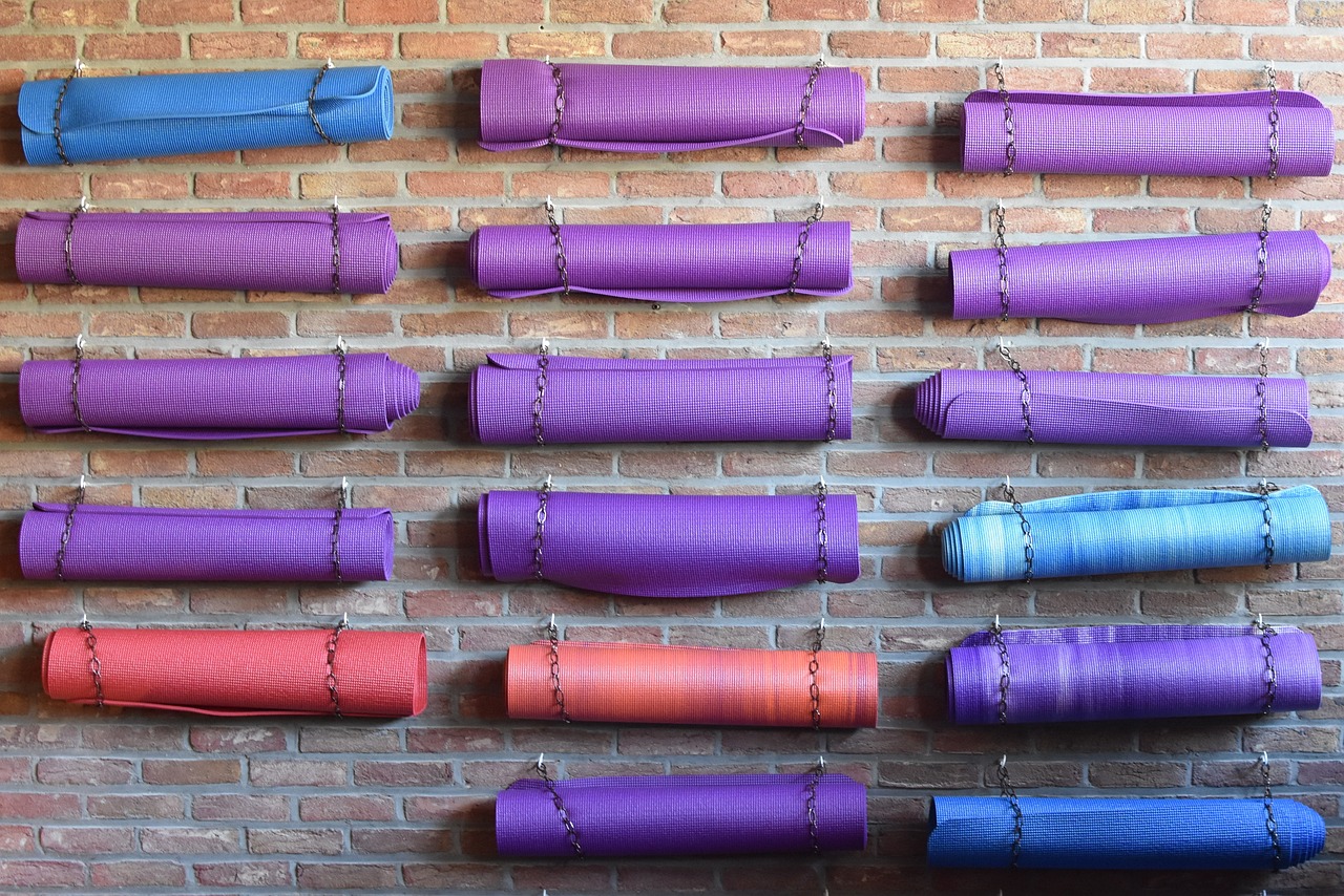 Colorful yoga mats on brick wall
