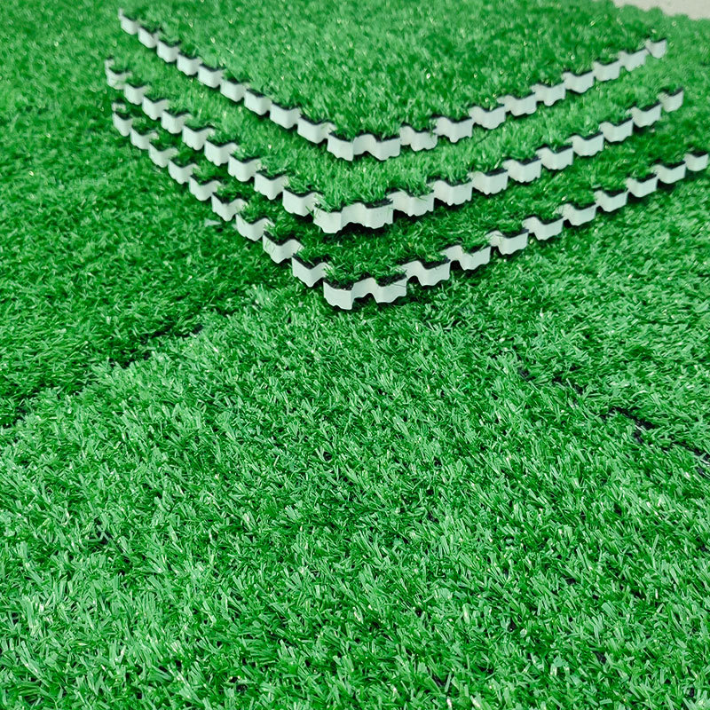 Stacked green artificial grass tiles